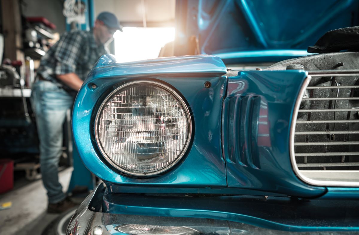 classic-cars-restoration-worker-next-to-his-restor-2023-11-27-05-17-51-utc