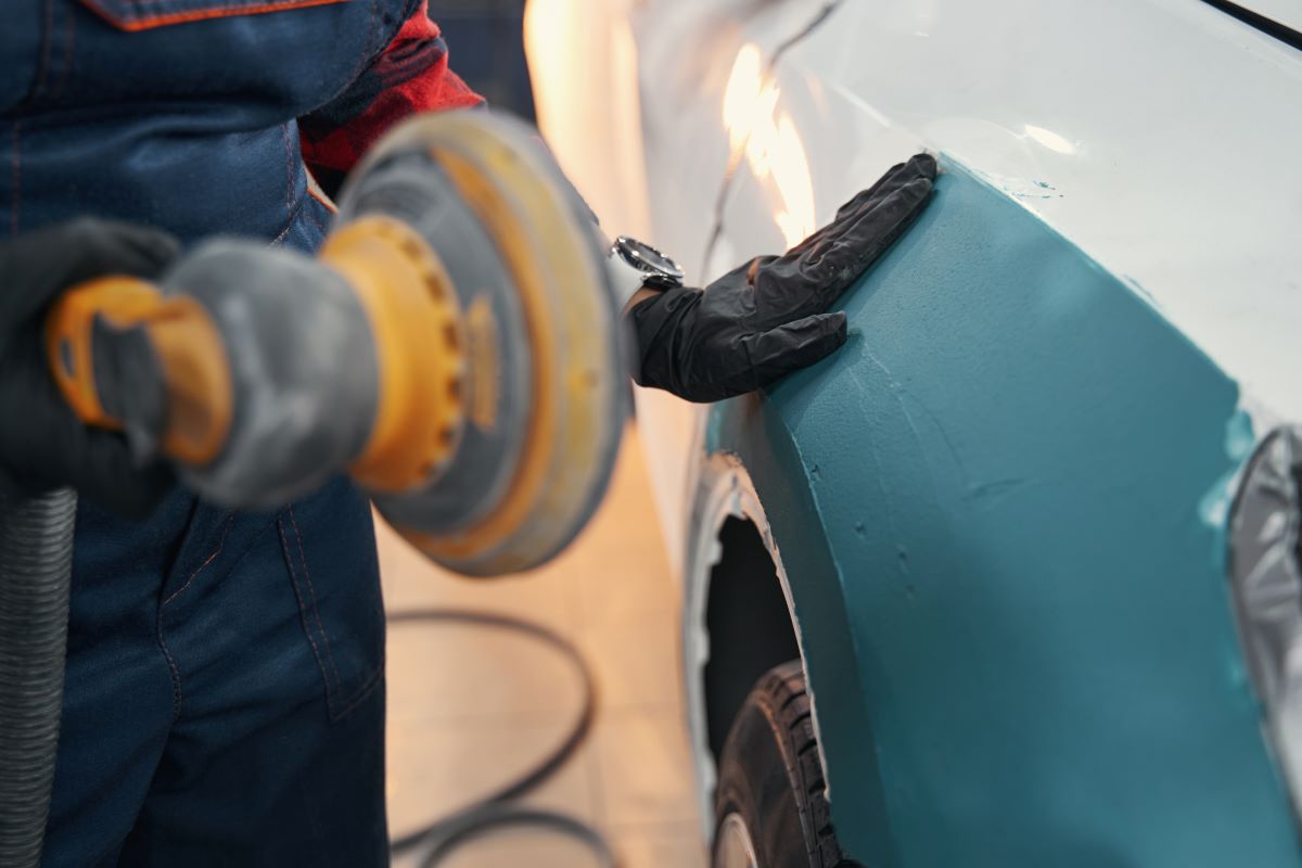 close-up-of-mechanic-cleaning-car-body-2023-11-27-04-49-30-utc